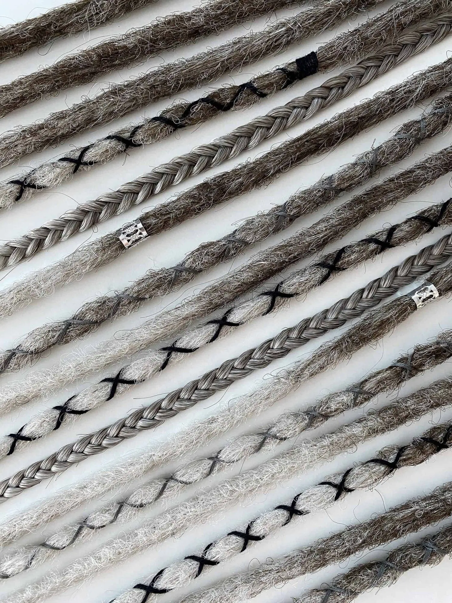 Viking brown grey ombre crochet dread extensions extreme macro showing X-pattern wraps and tribal beads