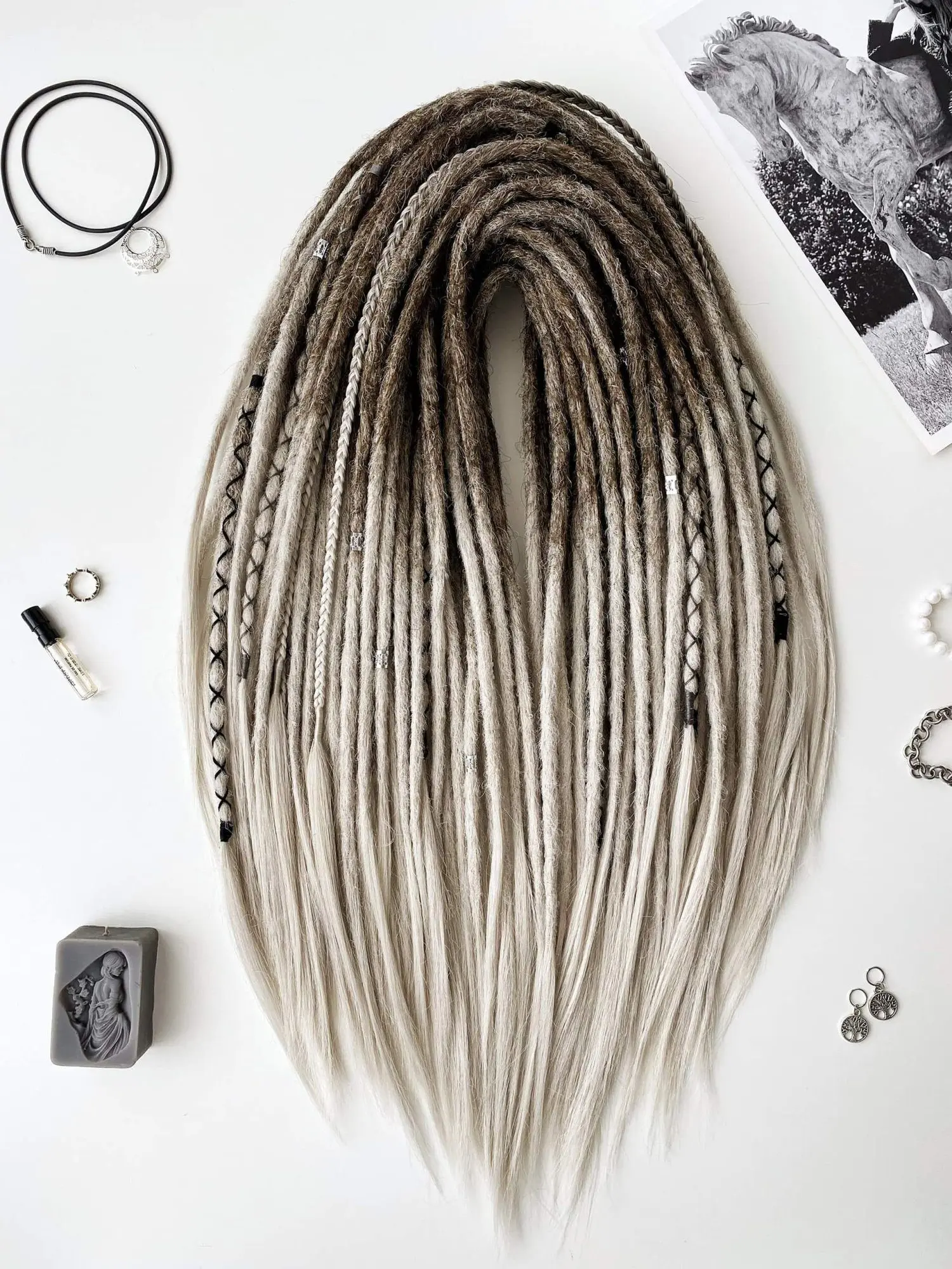 Viking ash blonde ombre crochet dreadlock extensions full vertical flatlay with horse statue print