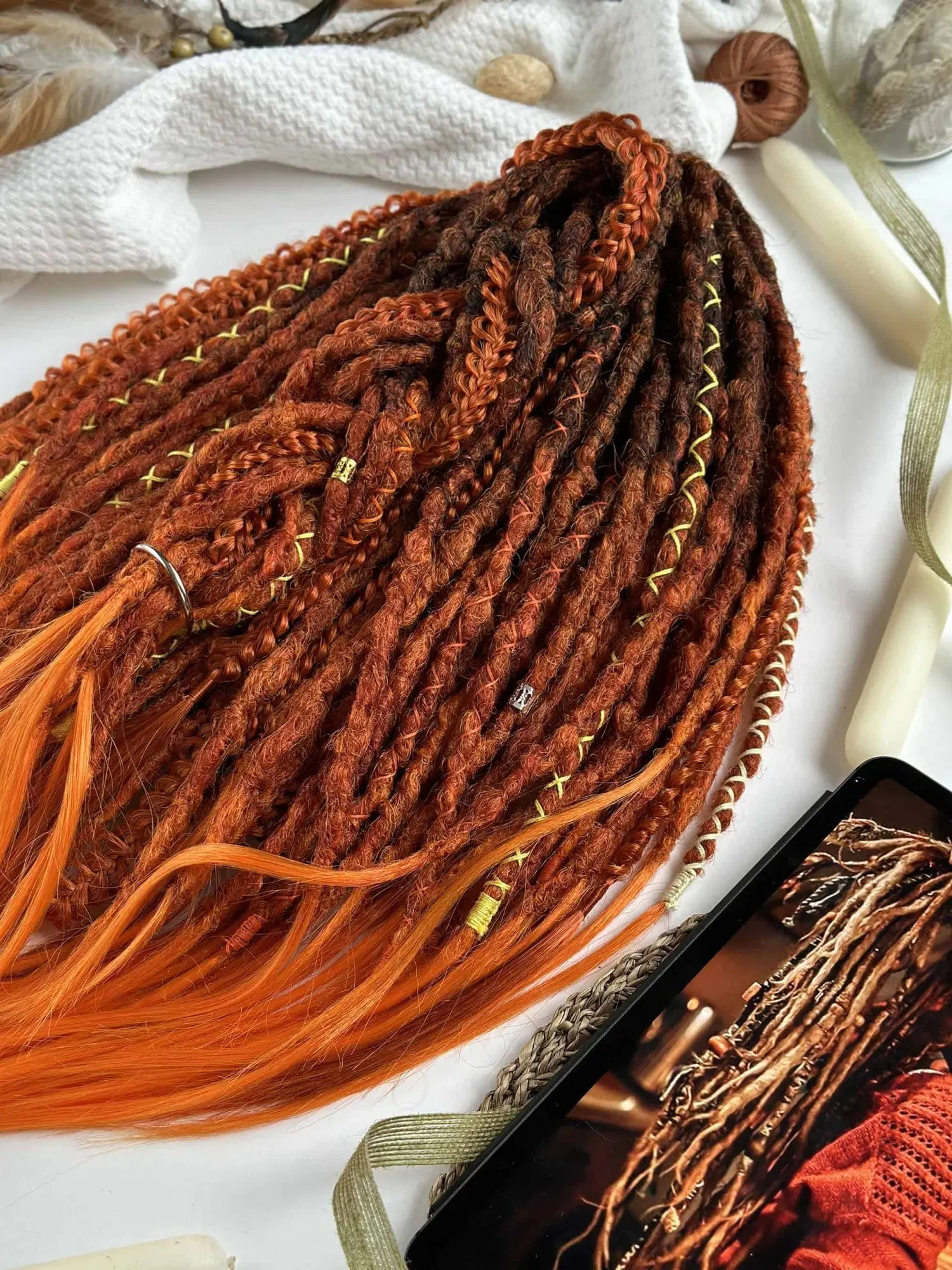 Ginger textured dread extensions with yellow thread wraps and gold beads close-up