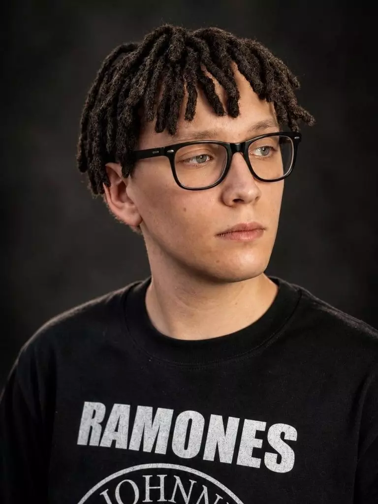 Short temporary synthetic DE dreads on a man with glasses