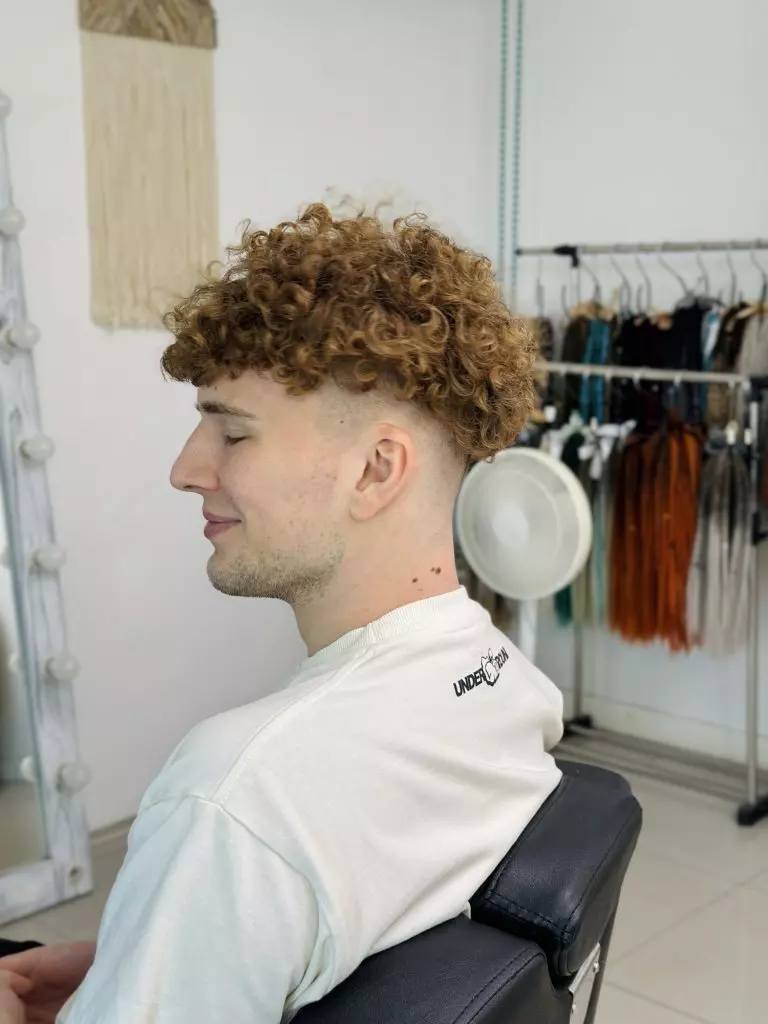 Client with short curly hair in the DaddyDread studio before natural dreads on the crown