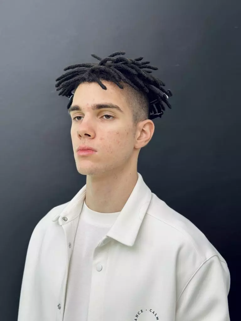 Short black natural dreadlocks on top with an undercut, front view